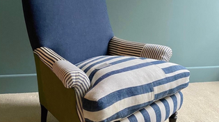  Blue and off-white colour striped chair. The back of the chair is a solid navy blue colour. The chair is facing the camera at an angle.